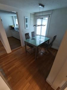 a dining table and chairs in a living room at Apartment on 2 floors in Stäfa