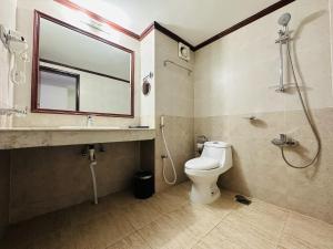 a bathroom with a toilet and a sink and a shower at Uni Resort in Cox's Bazar