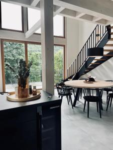 a room with a table and chairs and a staircase at Ferienhaus MOSELLODGE in Enkirch