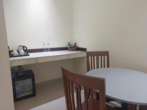 a kitchen with a table and a table and chairs at Uni Resort in Cox's Bazar +30 photos