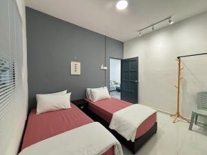a room with two beds in a room at Jementah Homestay 18 in Jementah