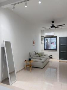 a living room with a couch and a ceiling fan at Jementah Homestay 18 in Jementah