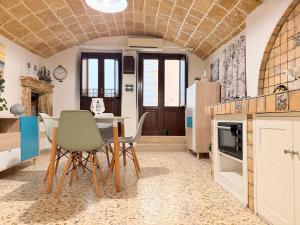 a kitchen with a table and chairs in a room at Perla Del Borgo in Gallipoli