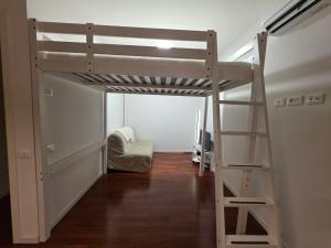 a room with a bunk bed and a ladder at Casa SanZvan - Appartamento in San Giovanni in Persiceto