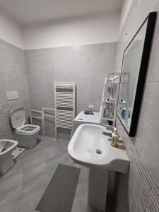 a white bathroom with a sink and a toilet at Casa SanZvan - Appartamento in San Giovanni in Persiceto