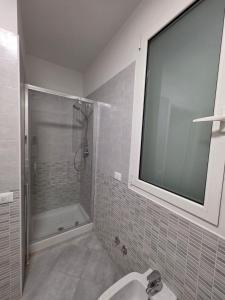 a white bathroom with a shower and a sink at Casa SanZvan - Appartamento in San Giovanni in Persiceto