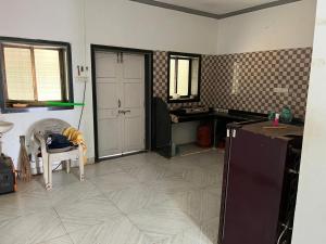 a room with a kitchen with a door and a table at Beach front in Murud