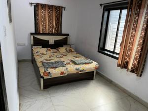 a bedroom with a bed in a room at Beach front in Murud