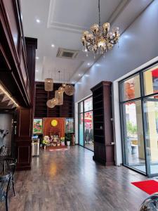 a living room with a chandelier and a large room at Ruby hotel Tuần Châu in Ha Long