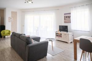 a living room with a couch and a tv at Bungalow Klüver in Ueckermünde