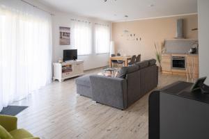 a living room with a couch and a table at Bungalow Klüver in Ueckermünde