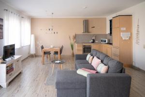 a living room with a couch and a table at Bungalow Klüver in Ueckermünde