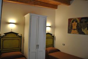a bedroom with two beds and a painting on the wall at Bed & Breakfast Palazzo Ducale in Andria