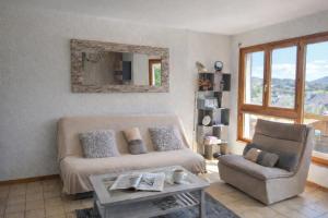 a living room with a couch and a chair at Haut Doubs Belvédère in Les Hôpitaux-Neufs
