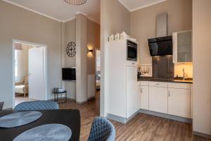 a kitchen and living room with a table and chairs at Rodehuus Wohnung 1 in Borkum