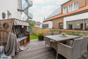an outdoor patio with a table and chairs at Rodehuus Wohnung 1 in Borkum +3 photos