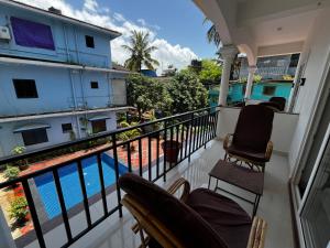 a balcony with chairs and a view of a pool at Morjim Sunset Hotel in Morjim