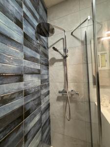 a bathroom with a shower with a glass door at Hostal Quinto Pino in Chipiona +112 photos