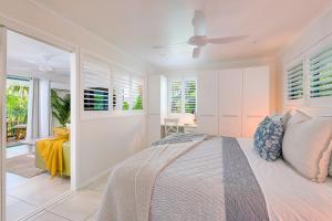 a bedroom with a bed and a view of a room at Chez Noosa Holiday Apartments in Sunshine Beach +31 photos