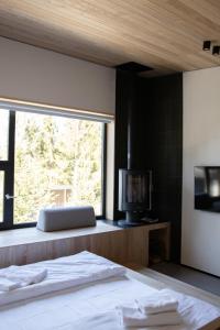 a bedroom with a bed and a window with a television at Moho in Yablunytsya +53 photos