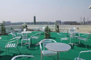 a group of tables and chairs on a roof at Holiday Xpress in Dhaka