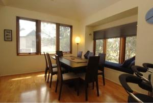 a dining room with a table and chairs at Blue Sky Lodge in Dinner Plain