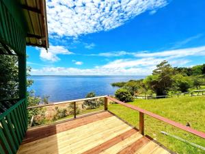 a deck with a view of the water at Luz Amazônia Lodge in Aiparuça