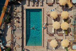 an overhead view of a swimming pool with people sitting around it at Jacy'z Hotel & Resort in Gothenburg