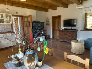 a living room with a vase on a wooden table at Chalupa Vlachovice in Vlachovice