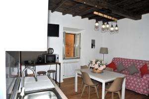 a living room with a table and a couch at Il Valentino in Castel Gandolfo +15 photos