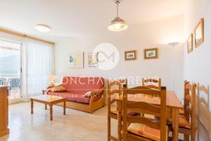 a living room with a table and a couch at Señorio de Oropesa-CM in Oropesa del Mar +10 photos