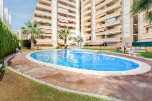 a swimming pool in front of a large building at Señorio de Oropesa-CM in Oropesa del Mar