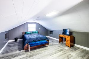 a bedroom with a bed and a tv in a attic at Orange Queen LLC in East Orange