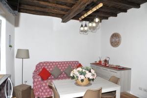 a living room with a table and a couch at Il Valentino in Castel Gandolfo