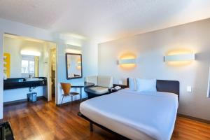 a hotel room with a bed and a desk at Motel 6-Pleasanton, CA in Pleasanton