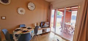 a dining room with a table and a clock on the wall at Ti Ker Créole in Saint-Benoît +4 photos