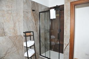 a bathroom with a glass shower with white towels at Il Valentino in Castel Gandolfo