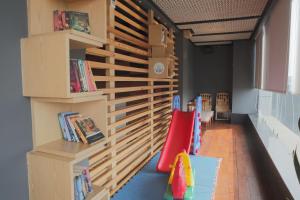 a childs room with a wall of bookshelves at Hotel Subansiri in Dibrugarh