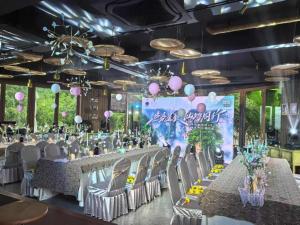 a banquet hall with tables and chairs and balloons at Evergreen Forest Retreat Zhangjiajie, Near National Forest Park Avator Park, Luxury Nature Escape, Free Airport&Train Shuttle Service & Travel itinerary, English Speaking Butler in Zhangjiajie +187 photos
