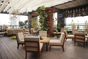 a restaurant with tables and chairs on a patio at Hotel Subansiri in Dibrugarh