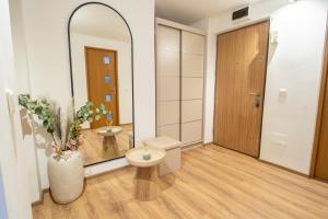 a bathroom with a toilet and a mirror at Ovideli Apartment in Ocna-Mureşului