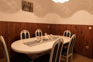 a dining room table with chairs and a table and a table and chairsktop at Goričko Homes in Mačkovci +2 photos
