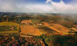 an aerial view of a farm on a hill at Goričko Homes in Mačkovci