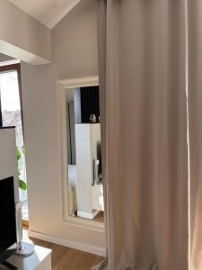 a living room with a mirror and a window at Piska Przystań in Pisz +11 photos