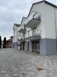 a white building with balconies on the side of it at Piska Przystań in Pisz
