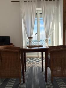a dining room table with a view of the ocean at Le Petit Café L'arriere Cour in Cancale