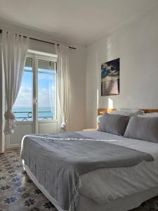 a bedroom with a bed with a view of the ocean at Le Petit Café L'arriere Cour in Cancale