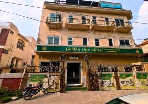 a motorcycle parked in front of a building at Golden One Hotel in Lahore +41 photos