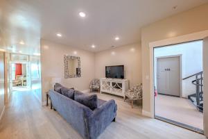 a living room with a couch and a television at Historic Main Street Hotel in Pleasant Grove