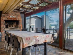 a dining room with a table and a fireplace at Haweweg 5 in Struisbaai